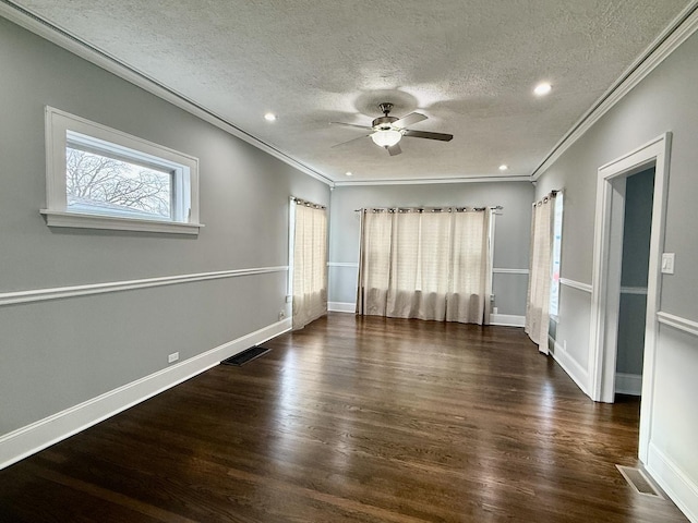 spare room with crown molding, ceiling fan, dark wood-type flooring, and a textured ceiling