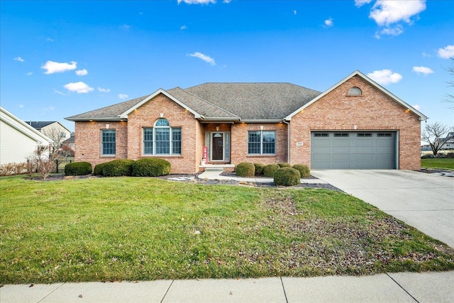 view of front of property with a garage and a front lawn