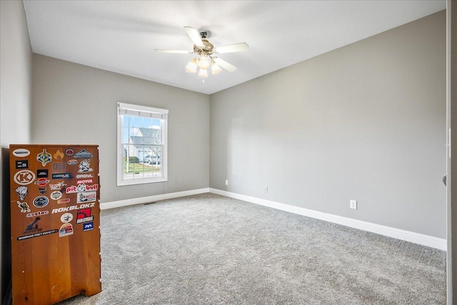 carpeted empty room with ceiling fan