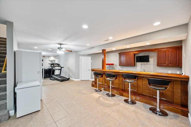 bar featuring refrigerator and ceiling fan