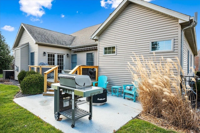 rear view of property with a patio and a wooden deck