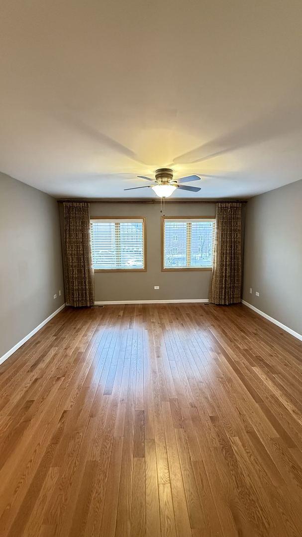 spare room with hardwood / wood-style floors and ceiling fan