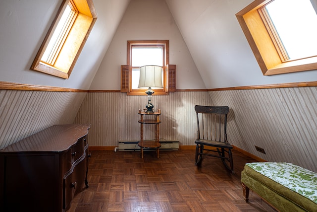 living area with baseboard heating, dark parquet flooring, and lofted ceiling with skylight