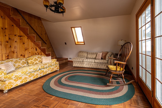 living room featuring parquet flooring and a skylight