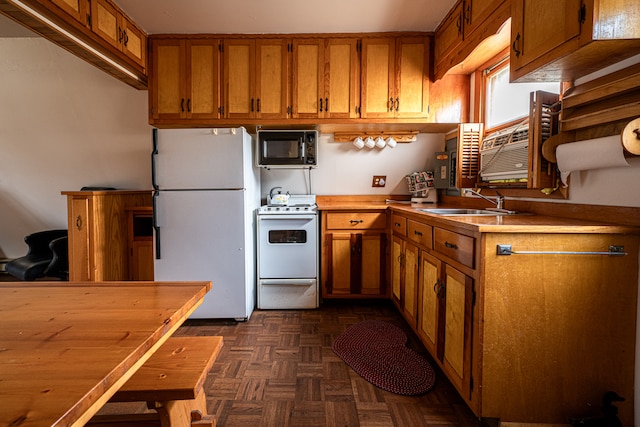 kitchen with dark parquet flooring, white appliances, and sink