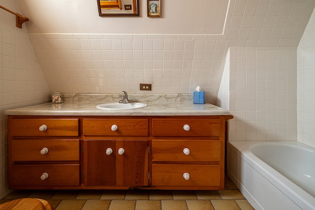 bathroom with shower / tub combination, vanity, and tile walls