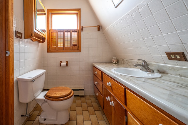 bathroom featuring vaulted ceiling with skylight, vanity, tile walls, and toilet