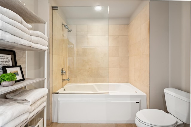 bathroom featuring tub / shower combination and toilet