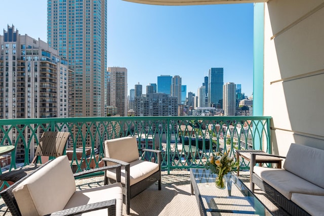 balcony featuring an outdoor living space and a city view