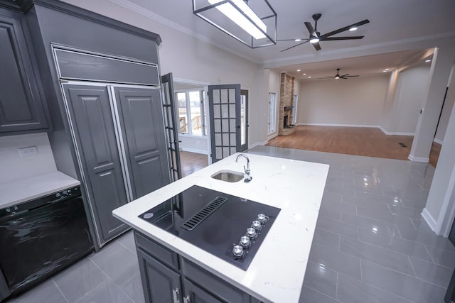 kitchen featuring gray cabinetry, crown molding, black appliances, sink, and hardwood / wood-style floors