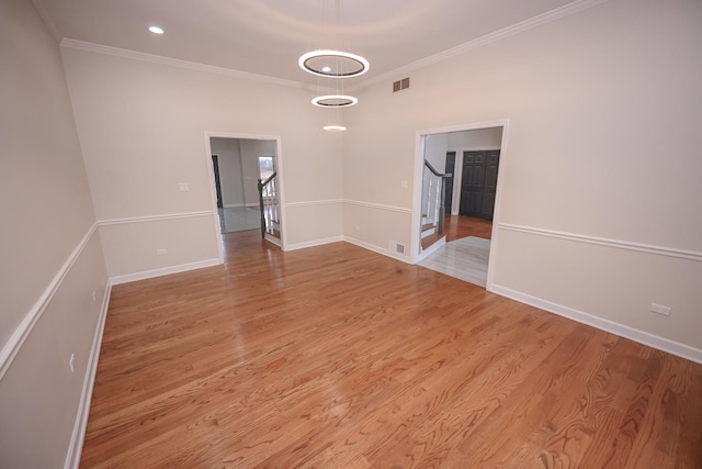 unfurnished room featuring light hardwood / wood-style floors and ornamental molding