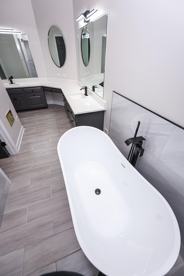 bathroom with a bathing tub and vanity