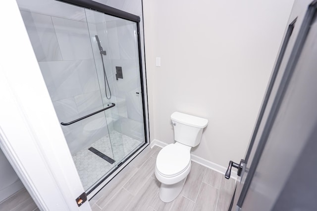 bathroom with toilet and walk in shower