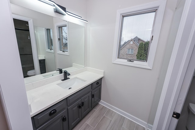 bathroom featuring vanity and toilet