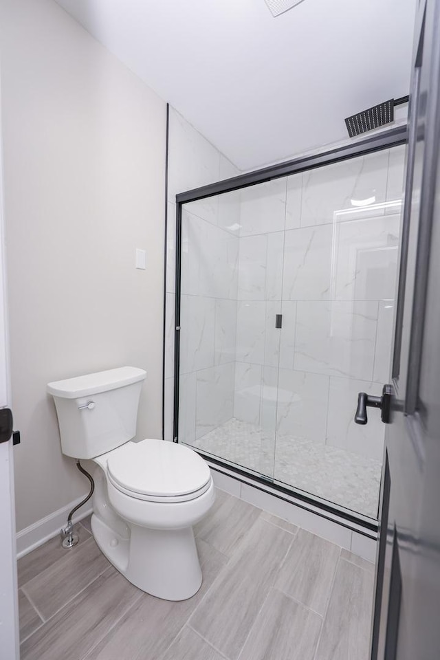 bathroom with toilet and walk in shower