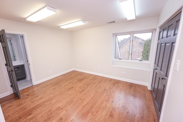 spare room featuring light hardwood / wood-style flooring