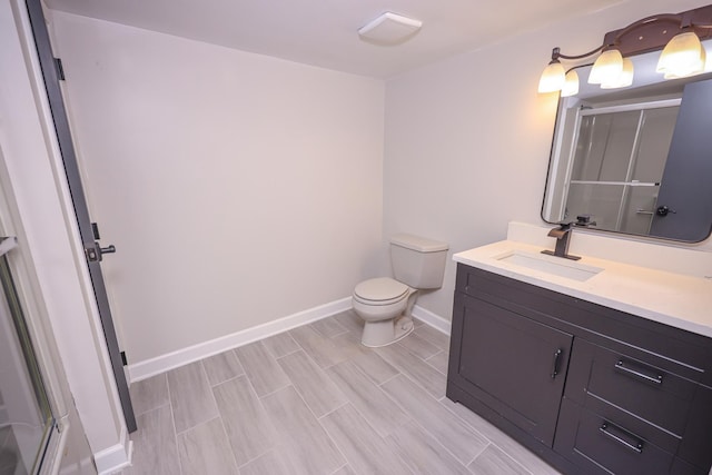 bathroom featuring vanity, toilet, and walk in shower