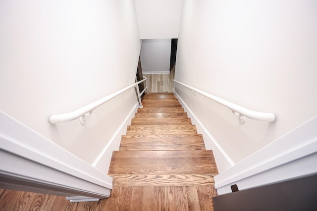 stairs featuring wood-type flooring