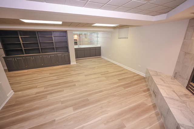 basement with light hardwood / wood-style floors