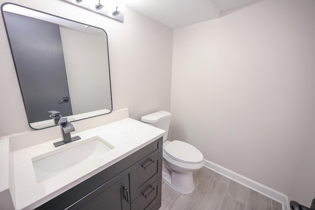 bathroom featuring hardwood / wood-style floors, vanity, and toilet