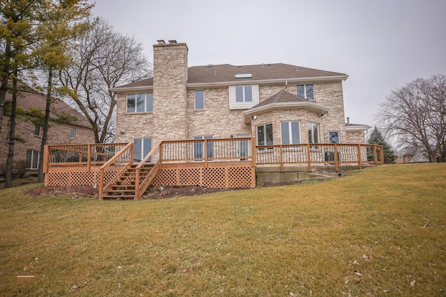 back of property featuring a lawn and a deck