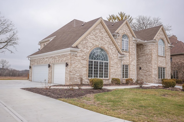 front of property with a garage and a front lawn