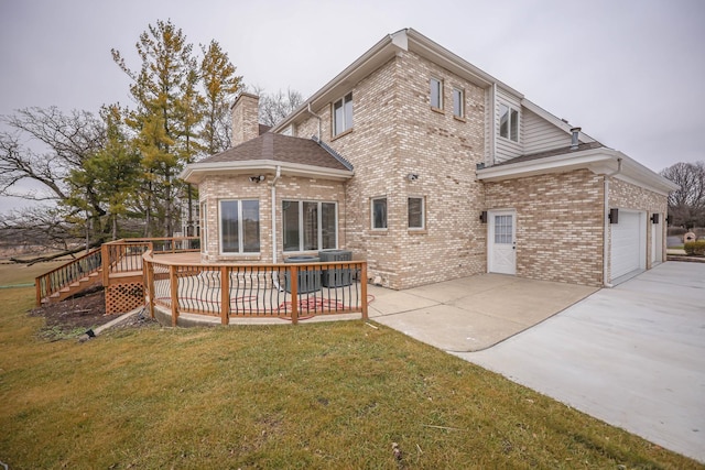 rear view of house featuring a lawn, a wooden deck, and central AC