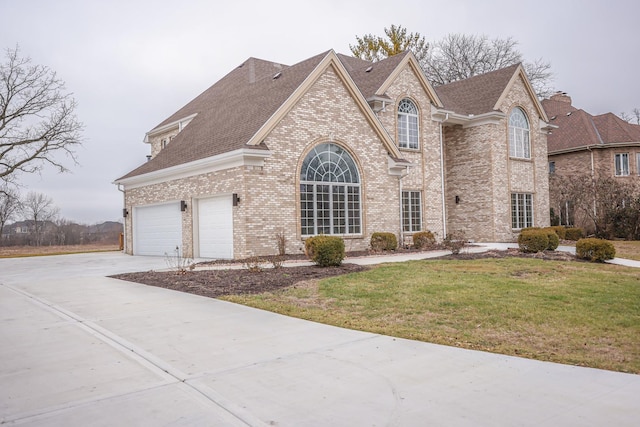 view of front of home featuring a garage and a front lawn