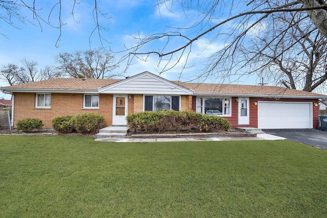 single story home featuring a front lawn and a garage