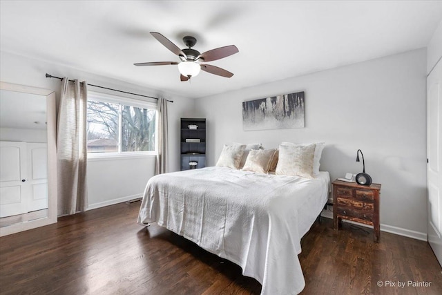 bedroom with dark hardwood / wood-style floors and ceiling fan