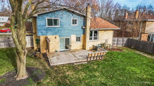 rear view of house featuring a lawn