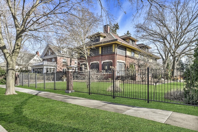 exterior space with brick siding, a chimney, a front yard, and fence