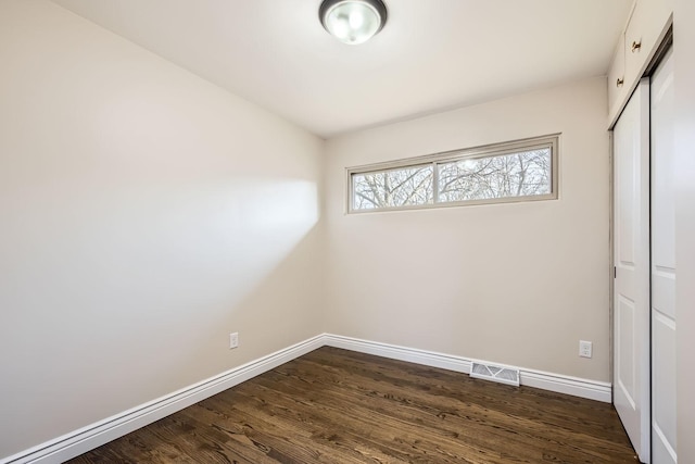 empty room featuring dark wood-type flooring