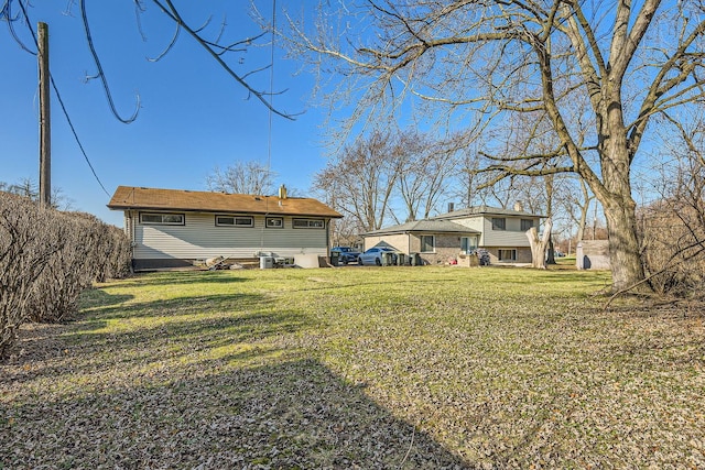 rear view of property with a yard