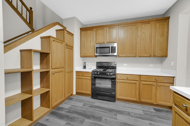 kitchen with light hardwood / wood-style flooring and black range with gas cooktop