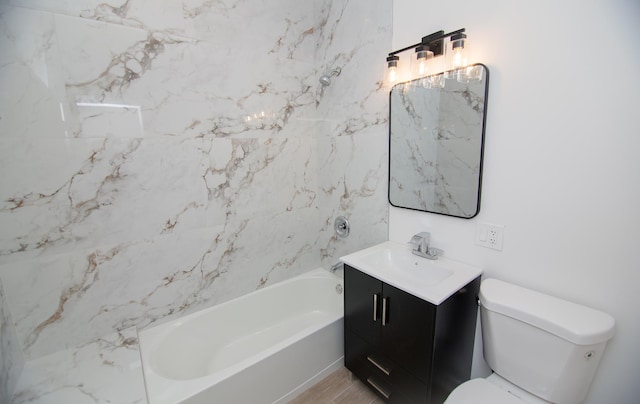 full bathroom with vanity, toilet, and tiled shower / bath