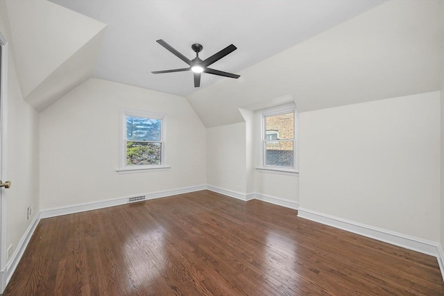 bonus room with ceiling fan, dark hardwood / wood-style floors, and vaulted ceiling