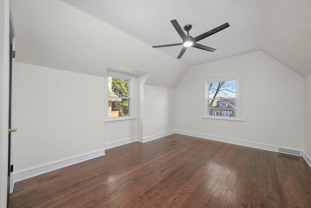 additional living space featuring ceiling fan, lofted ceiling, and dark wood-type flooring