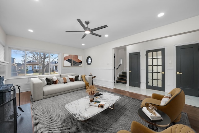 living room with wood-type flooring and ceiling fan