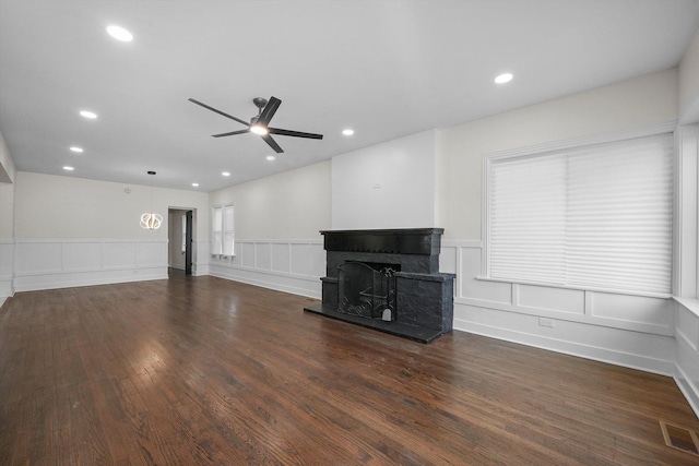 unfurnished living room featuring dark hardwood / wood-style flooring and ceiling fan