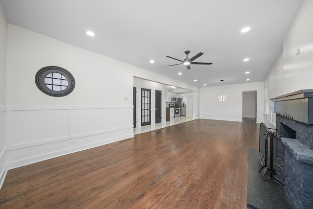 living room with dark hardwood / wood-style flooring and ceiling fan