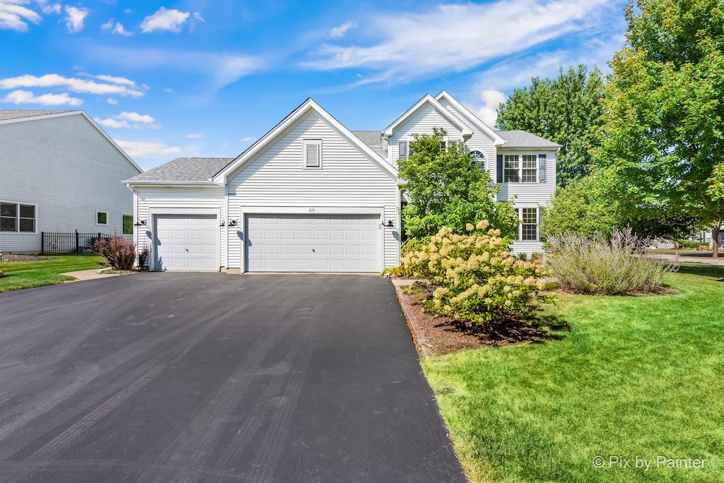 front of property with a garage and a front yard