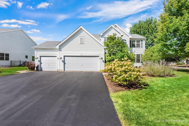 front of property with a garage and a front yard