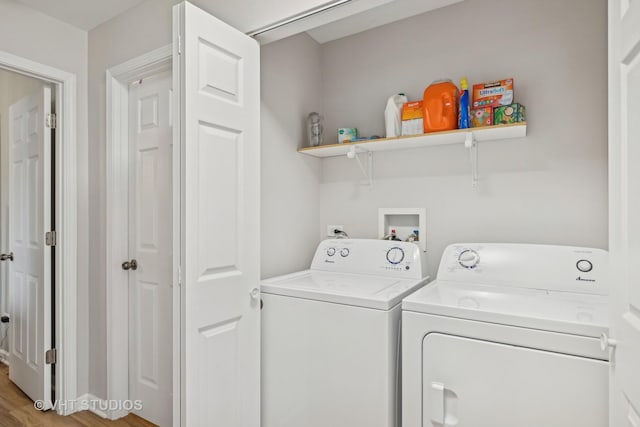 clothes washing area featuring hardwood / wood-style floors and separate washer and dryer