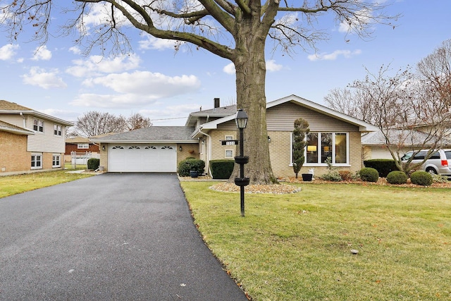 view of front of house with a garage and a front lawn