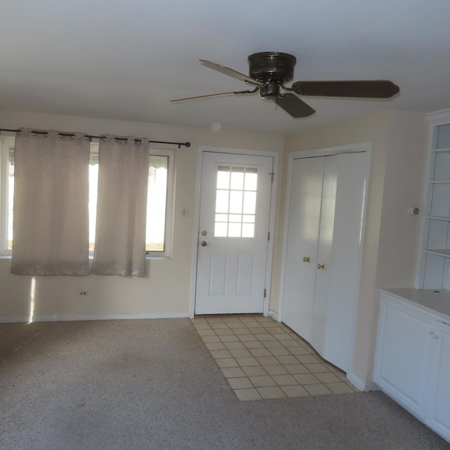 tiled entrance foyer with ceiling fan