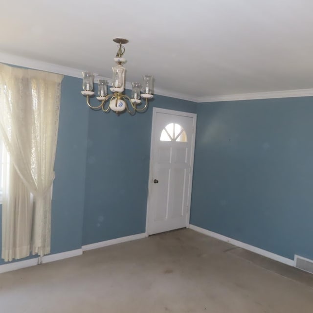 foyer entrance featuring a chandelier, carpet, and crown molding