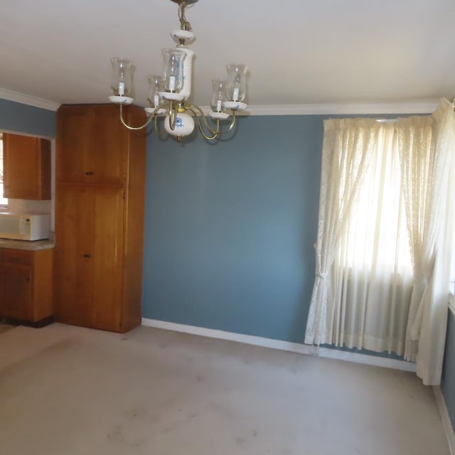 unfurnished dining area with light carpet, crown molding, and a notable chandelier