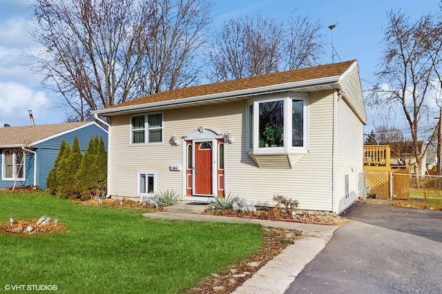 split foyer home with a front lawn