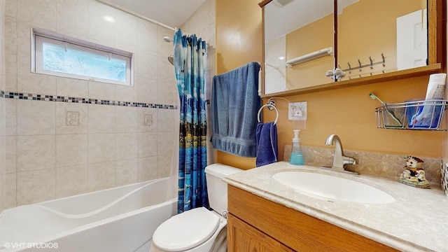 full bathroom with vanity, shower / bath combination with curtain, and toilet